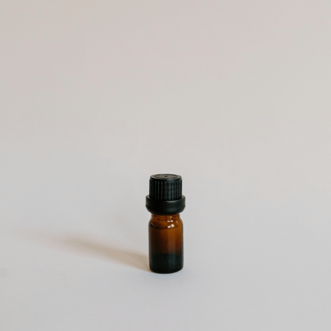 essential oil bottle on simple background