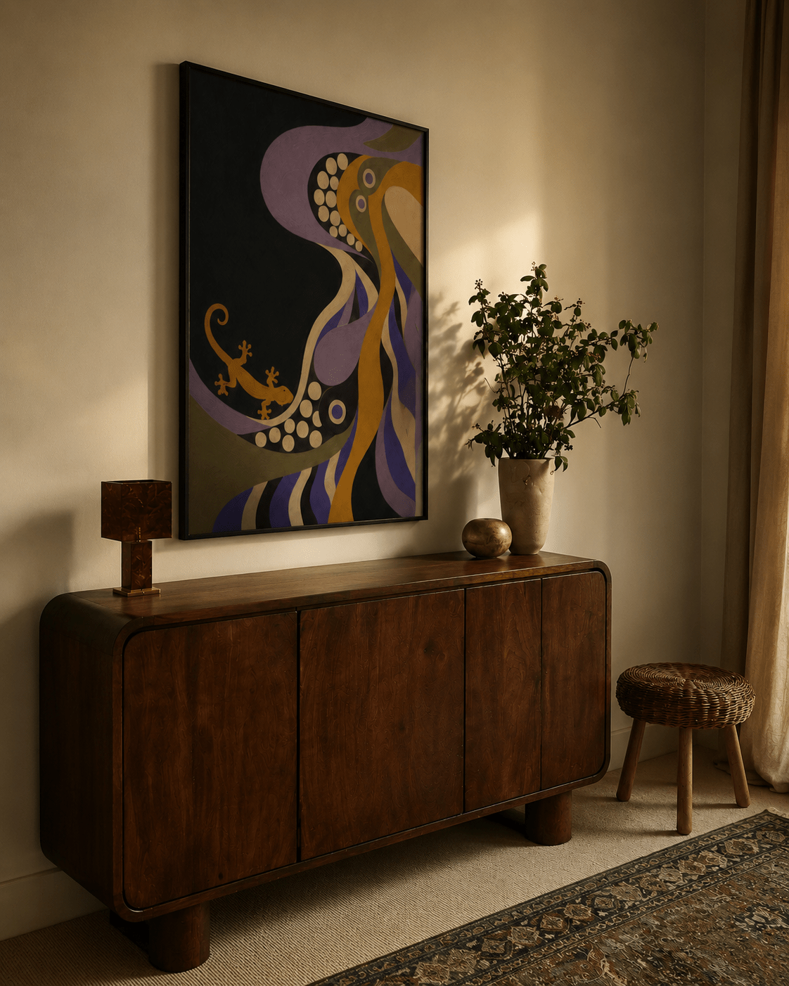A framed abstract wall art print hangs above a dark wood sideboard in a warmly lit room. The artwork features flowing organic shapes in purple, mustard yellow, cream, and black.