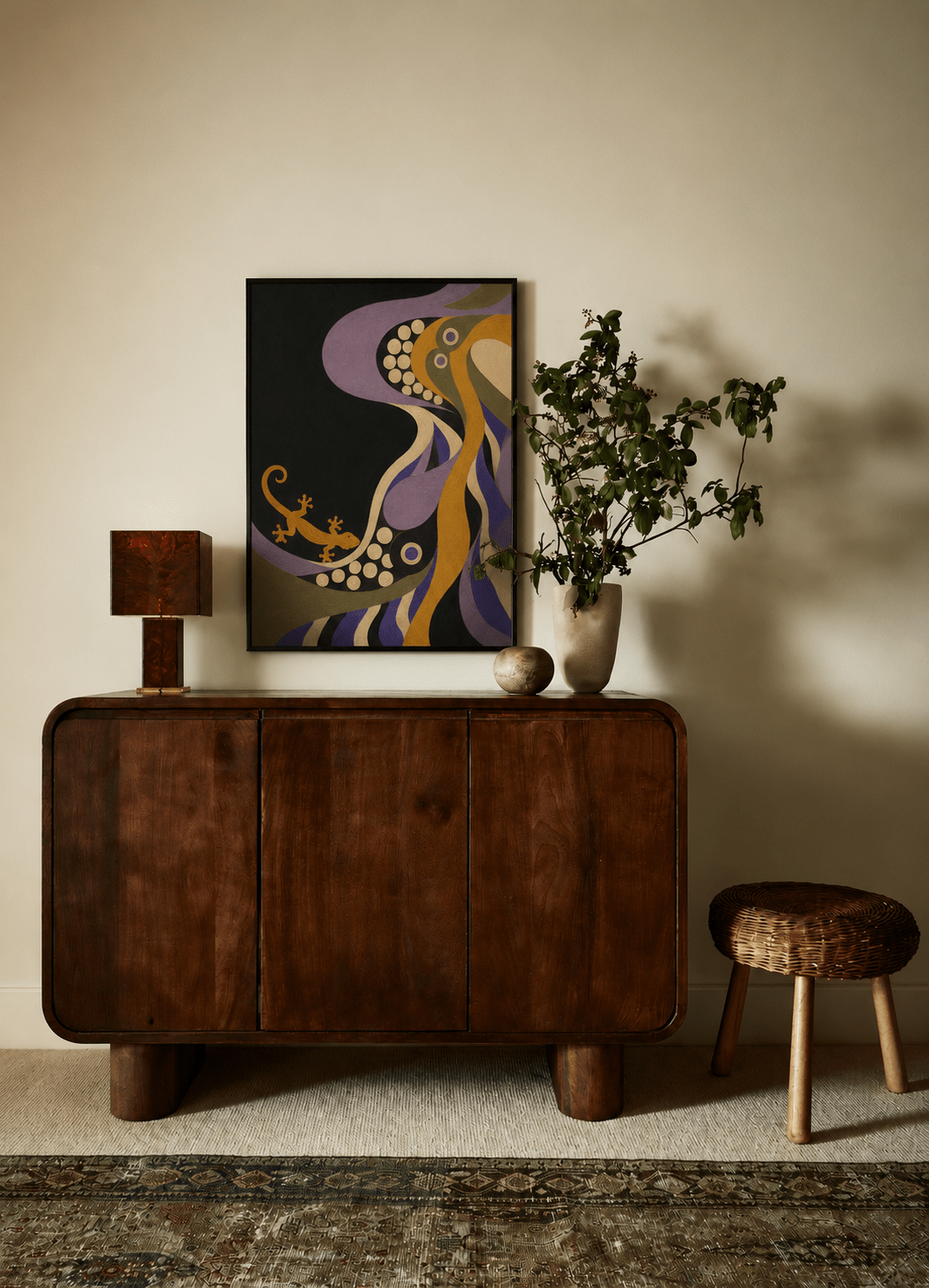 A mid-century modern dark wood credenza or sideboard cabinet styled in a warm, minimalist room. Above it hangs a colorful abstract art print featuring purple, gold, and black.