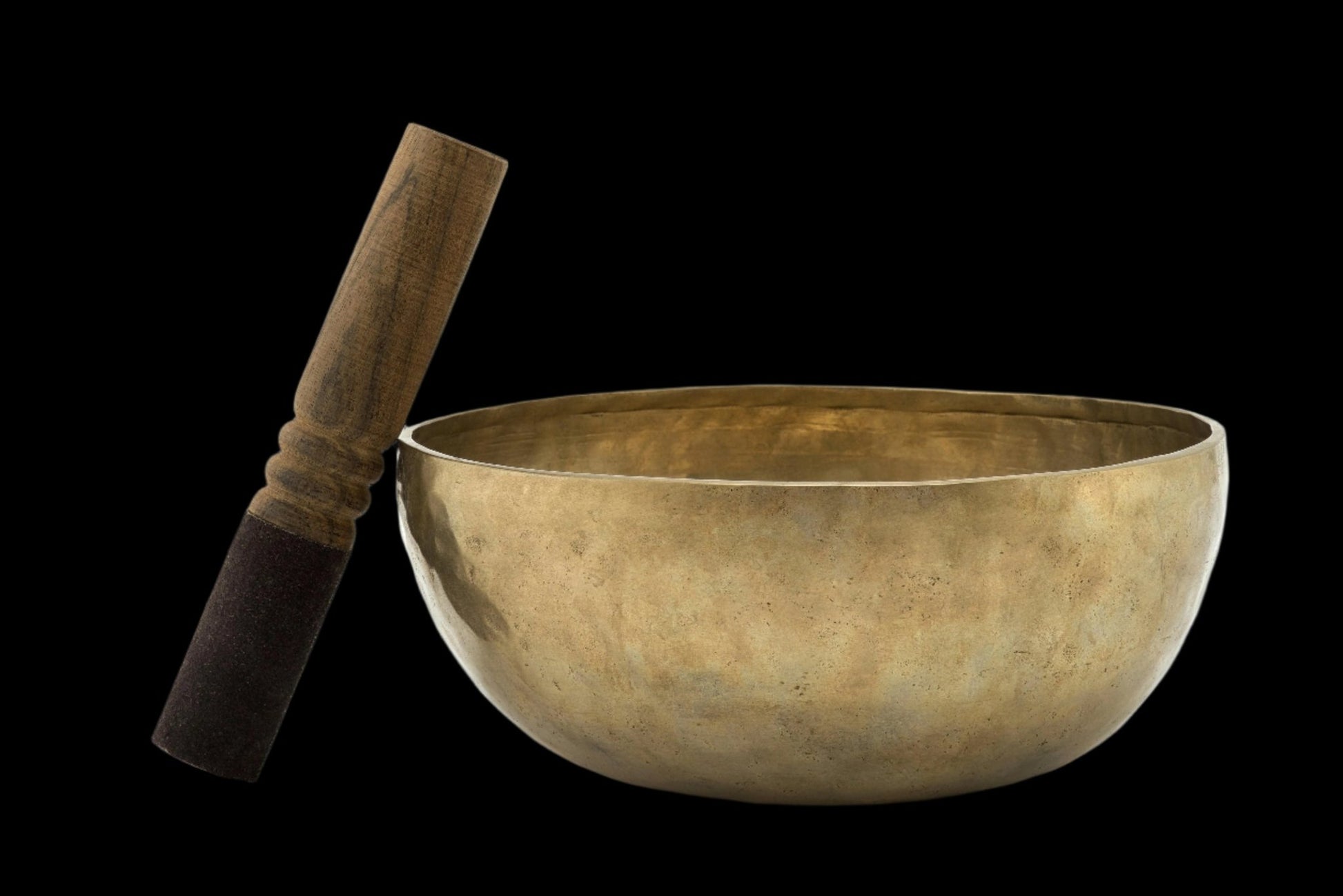 brass tibetan singing bowl with wooden striking mallet 